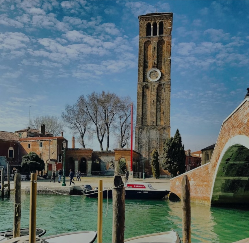 Bell tower and canal view of Murano island, Venice Lagoon.